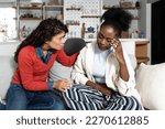 Small photo of Young African American woman exchange student girl crying and feeling hurt and miserable because of verbal racial attack insults in a public or on social network sites on internet. Stop racism concept