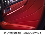 Luxurious car doors covered with red leather with LED lights.