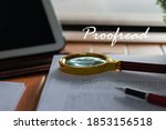 Small photo of magnifier on blurred proofreading paper with proofread text floating above on wooden table nearby window in office