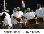 Small photo of Doha, Qatar - November 26, 2022: Omani men practice the Omani art of Razha in their traditional dress and drums.