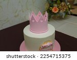 Beautiful girlish birthday cake with pink mastic crown, bow, inscription name Maria. One year old or five years old birthday cake, sweet dessert treat