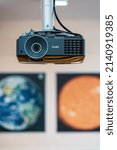 Small photo of Multimedia projector BenQ MX503 mounted on the ceiling in a geography classroom. Posters of the planet Earth and Mars on the background. Ukraine, Kharkiv, Professional College of NUFU, 17.02.2022.