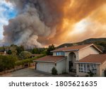 The California "River Fire" of Salinas,  in Monterey County, was ignited by dry lightning on August 16, 2020, fills the sky with dark smoke and flames as it burns close to a houses on its first day.  