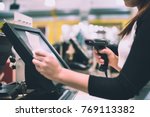 Young woman hands scaning / entering discount / sale on a receipt, touchscreen cash register, market / shop (color toned image)