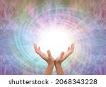 Small photo of Channeling healing energy vortex spiral - female cupped hands reaching up into a white vortex energy against a multicoloured spiralling light background with copy space