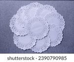 Doilies white paper on grey background. shot on top.