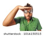 Man with funny expression and thick glasses looking far away on white background.