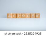 Small photo of Wooden blocks form the text "Antonym" against a white background.