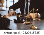 Small photo of Focus shiny golden balanced scale on blurred background of lawyer colleagues working on desk at law firm office. Scale balance for righteous and equality judgment by lawmaker and attorney. Equilibrium