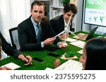 Small photo of Diverse group of business people planning for alternative energy utilization for greener sustainable Earth by reducing CO2 emission and carbon credit with renewable clean energy technology. Quaint