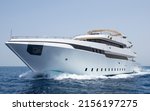 Small photo of A large luxury private motor yacht under way sailing on tropical sea with bow wave