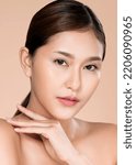 Small photo of Closeup ardent young woman with healthy clear skin and soft makeup looking at camera and posing beauty gesture. Cosmetology skincare and beauty concept.