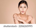 Small photo of Portrait of ardent young woman with healthy clear skin and soft makeup looking at camera and posing beauty gesture. Cosmetology skincare and beauty concept.