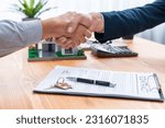 Small photo of Finalizing house loan agreement with handshake, buyer and real estate agent celebrate accomplishment of property ownership with sense of satisfaction. New home owner shake hand with broker. Entity