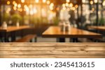 Small photo of The empty wooden table top with blur background of restaurant. Exuberant image.