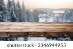 Small photo of The empty wooden dark brown rustic table top with blur background of winter forest in finland. Exuberant image.