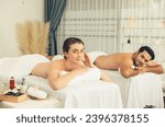 Small photo of Blissful couple customer having exfoliation treatment in luxury spa salon with warmth candle light ambient. Salt scrub beauty treatment in health spa body scrub. Quiescent