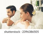 Small photo of Caucasian couple customer enjoying relaxing anti-stress spa massage and pampering with beauty skin recreation leisure in day light ambient salon spa at luxury resort or hotel. Quiescent