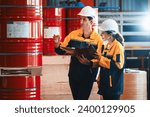 Small photo of Two factory workers or inventory inspector conduct professional inspection on hazardous chemical barrels in warehouse, chemistry storage workplace and industrial profession concept. Exemplifying