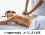 Small photo of Caucasian woman customer enjoying relaxing anti-stress spa massage and pampering with beauty skin recreation leisure in day light ambient salon spa at luxury resort or hotel. Quiescent