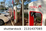 Small photo of Haifa, Israel - February 6, 2022: Tesla cars while charging at Tesla supercharger Station. Tesla Charging point.