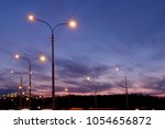 city lighting poles off the road, evening landscape