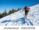Skialpinists on a snowy slope, Man and woman in winter trip to mountains, Alpine skier in snowy mountains