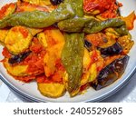 Small photo of Libyan Tbahij, TbAhij, Tabahej, Tabahaj, Tabahi, Tahaba or Tbahej Be El Hoot is a garnish for fried vegetables such as potatoes, zucchinis, eggplants, and green peppers, served with fish