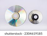 Compact disc with several sizes, view from above, with white background