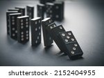 Black dominoes chain on a table ...