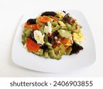 Small photo of Stir Fried Bitter Melon Mushrooms or Oseng Pare Jamur or Tumis Jamur Pare. Chinese food. Made from bitter melon, mushrooms, carrots and eggs. Served on a white plate and isolated on a white background