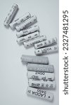 Small photo of AA and AAA size nimh batteries on a white background. Several batteries in a row. Space for text. Ikea Ladda NiMH rechargeable batteries. Orel, Russia - Feb 18 2023.