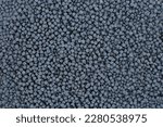 Small photo of Close-up of grey plastic polymer granules. polymer plastic. compound polymer. PVC resin compounds. Tinted plastic granulate for injection moulding process.