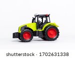 A Green Tractor Toy Car On A...