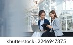 Small photo of Two asia business women in conversation walking together on city street. Corporate colleagues workmate discussing new project while going to work. business outdoor.