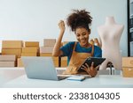 Small photo of Pretty African American sme business woman working Custom Ecommerce Packaging leading supplier of custom packaging. create a personalised experience, fast production and competitive pricing