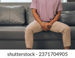 Small photo of Prostate cancer and men's health, Middle-aged Asian Indian man grappling with testicular discomfort. Vivid portrayal of male health challenges, urging awareness and timely medical consultations.
