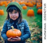 Young Girl Holding Pumpkin In A ...