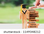 hand placing Student Sign wood with Graduation cap on wooden blocks tower. Space for letter e.g education, graduate, learning, motivation, studying etc. Ideas study to success. Back to School