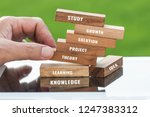 Study and education concept : Student hand placing wooden blocks tower for letter e.g learning, study, theory, knowledge, solution etc. Ideas goal study to success in life and business. Back to School
