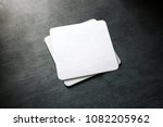 Small photo of Blank white beer coaster stack mockup, top view, lying on the textured background. Squared clear can mat design mock up isolated. Quadrate cup rug display