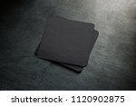 Small photo of Blank black beer coaster stack mock up, top view, lying on the textured background. Squared clear can mat design mockup isolated. Quadrate cup rug display