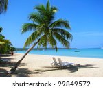 Beach chairs on tropical white sand beach, Negril, Jamaica
