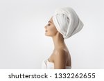 Spa skin care beauty woman wearing hair towel after beauty treatment. Beautiful multiracial young woman with perfect skin isolated on white background. Mixed race Caucasian Asian with closed eyes