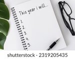 New Year's Resolutions Concept - Open notebook with text 