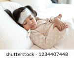 Medical check up and treatment concept. Mother is measure the temperature of little Asian kid girl. Sick child with fever and illness in bed.