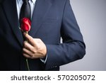 Business man hand with red rose flower on white background
