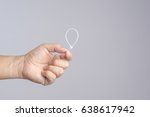 Hand holding self lock plastic cable on white background