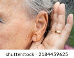Small photo of listening to problems Hand behind the ear to hear better. Hearing problems in older people, Close up of ear, ear and hand of deaf woman. Gesture to listen better in people with deafness, old ear woman