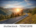 Motorcycle driver riding in Alpine highway,  Nockalmstrasse, Austria, Europe. Outdoor photography, mountain landscape. Travel and sport photography. Speed and freedom concept